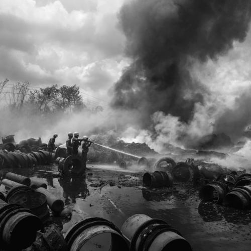Men under smoke clouds.