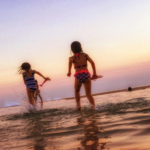 Sisters playing at sea with their dolls...