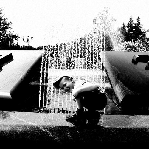 Happy boy near the fountain