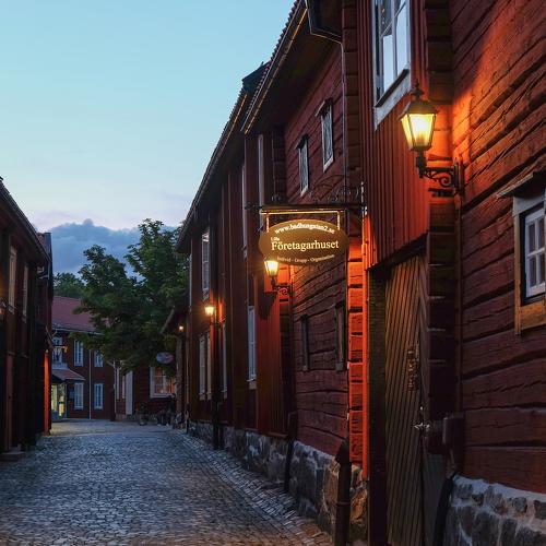A street in the center of Västerås, with traditional red wooden houses.