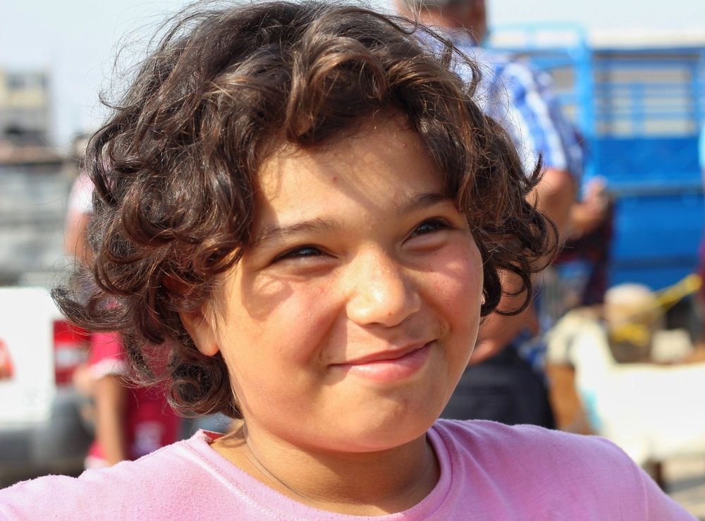 The girl with a beautiful smile in the market.